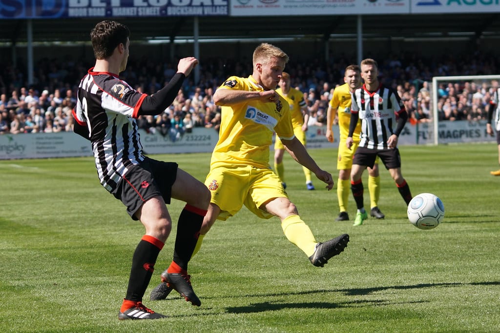 Footballers battle for a ball