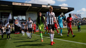 The Spennymoor Town and Darlington teams come out for the match