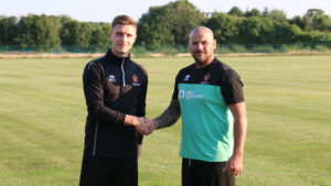Michael Ledger shaking hands with Bernard Morley