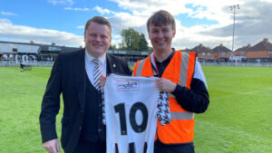 Ian Geldard presents the shirt to David Nelson