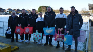 Spennymoor Town players and staff with food parcels for delivery