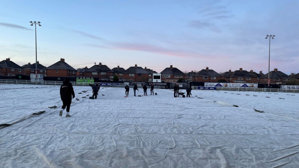 Volunteers help with the pitch at Spennymoor Town