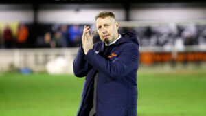 Spennymoor Town boss Jason Ainsley applauds the supporters