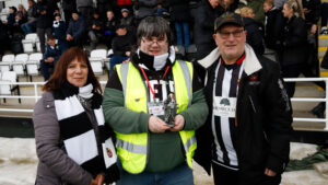 Chris Rowcroft receives his award from the Supporters' Club