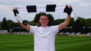 New Spennymoor Town signing Will Harris raises the Club scarf