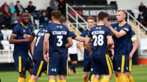 The Spennymoor Town players celebrate scoring a goal against Newcastle Blue Star