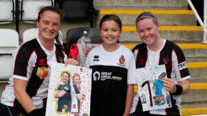 Spennymoor Town Ladies stars Autumn and Coral Colledge with a young fan