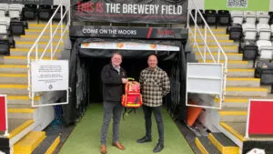 Ian Geldard accepts a donation of medical equipment from Nerams