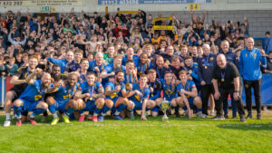 Leamington players and staff celebrate their promotion to National League North