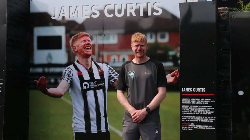 James Curtis in front of his Wall of Fame inistalment at Spennymoor Town