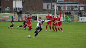 Spennymoor Town midfielder Matty Dolan takes a free kick against Shildon