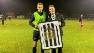 Jason Ainsley presents Spennymoor Town striker Glen Taylor with a framed shirt