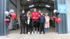 Spennymoor Town striker Glen Taylor cuts the ribbon at Treadmark Tyres