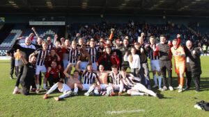 Spennymoor Town players and staff celebrate their FA Trophy semi-final win at Rochdale