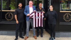 Spennymoor Town Managing Director Ian Geldard made a visit to Namaste with a signed shirt