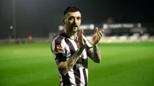 Midfielder Callum Ross applauds fans at The Brewery Field