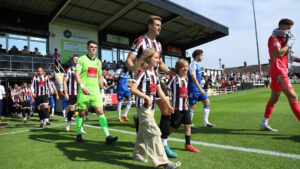 Spennymoor Town captain Glen Taylor leads the team out at The Brewery Field