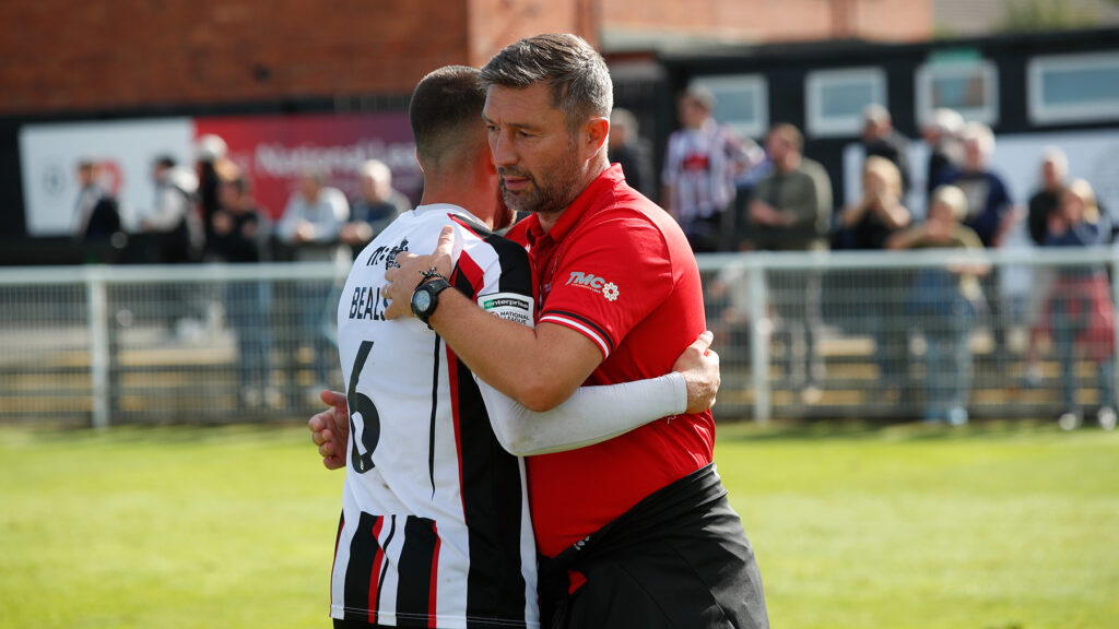 Spennymoor Town boss Graeme Lee congratulates defender Ben Beals after the win over Hereford