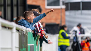 Young Spennymoor Town fans celebrate a goal at The Brewery Field