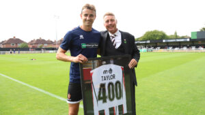 Spennymoor Town striker Glen Taylor is presented with a shirt by Head of Football Jason Ainsley