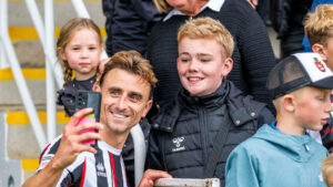Spennymoor Town player Glen Taylor takes a selfie with a supporter