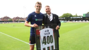 Spennymoor Town striker Glen Taylor is presented with a shirt by Head of Football Jason Ainsley
