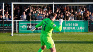 Spennymoor Town goalkeeper Ryan Johnson celebrates with fans at The Brewery Field