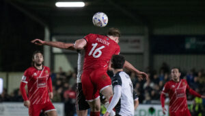 Spennymoor Town defender Ben Pollock challenges for the ball against Darlington