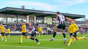 Spennymoor Town striker Glen Taylor heads on goal against Barrow