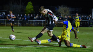 Spennymoor Town midfielder Mackenzie Heaney shoots on goal