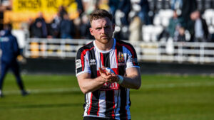 Spennymoor Town midfielder Mackenzie Heaney claps fans at The Brewery Field